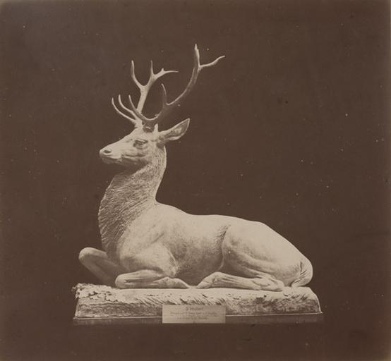 Cerf assis par Auguste Cain.1890 : Saint Huber attaqué au carrefour Saint-Remy forêt de Chantilly près de la Thève dans le village de Mongrésin après une partie de chasse le 4 9bre 1876 L.C. par Dupré_0