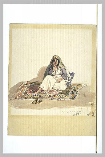 Femme syrienne assise sur un tapis d'Orient et sur un coussin bleu à fleurs_0
