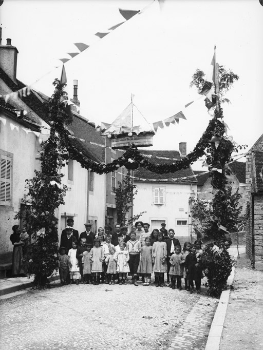 Rue décorée. Enfants et adultes sous un arc de triomphe R.F. (titre usuel), Jules Misserey, 20e siècle