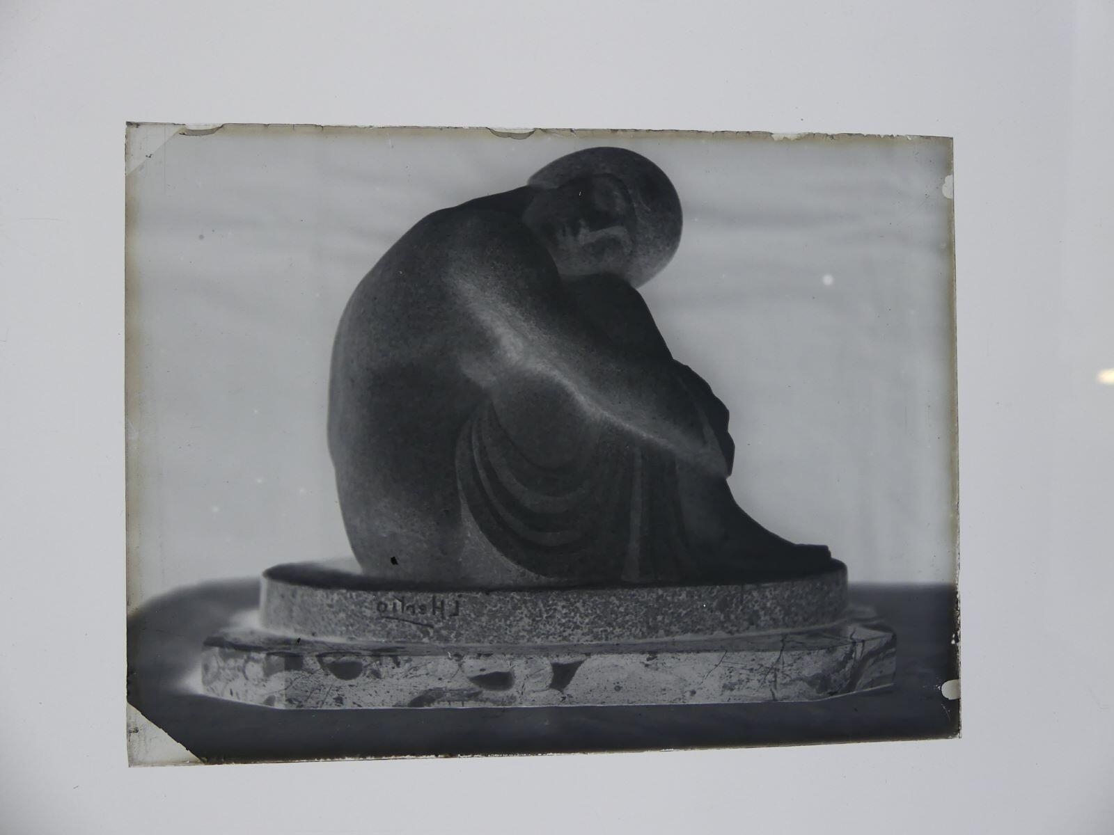 Groupe sculpté d'une femme assise, jambes repliées, la tête reposant sur ses genoux, photographiée dans l'atelier_1