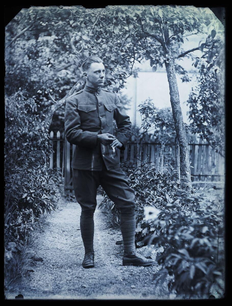Soldat américain en uniforme posant debout, dans un jardin_0