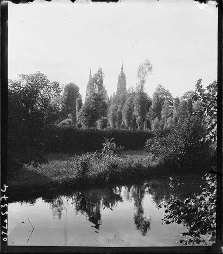 Vue éloignée sur les flèches et la tour, étang au premier plan