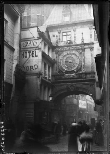 Ensemble de l'horloge et du porche sur une rue animée