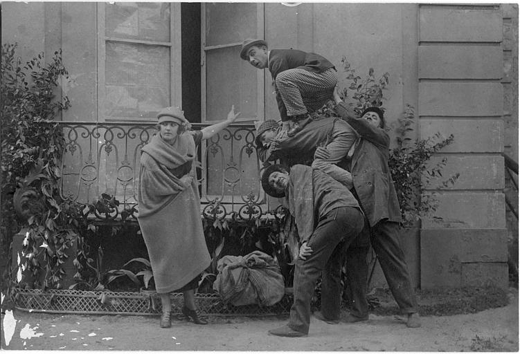Max, Gohier et Adolphe faisant la courte échelle à Rémond Frau dans le rôle de Dandy devant Milly Baker, pour entrer dans une maison par un balcon