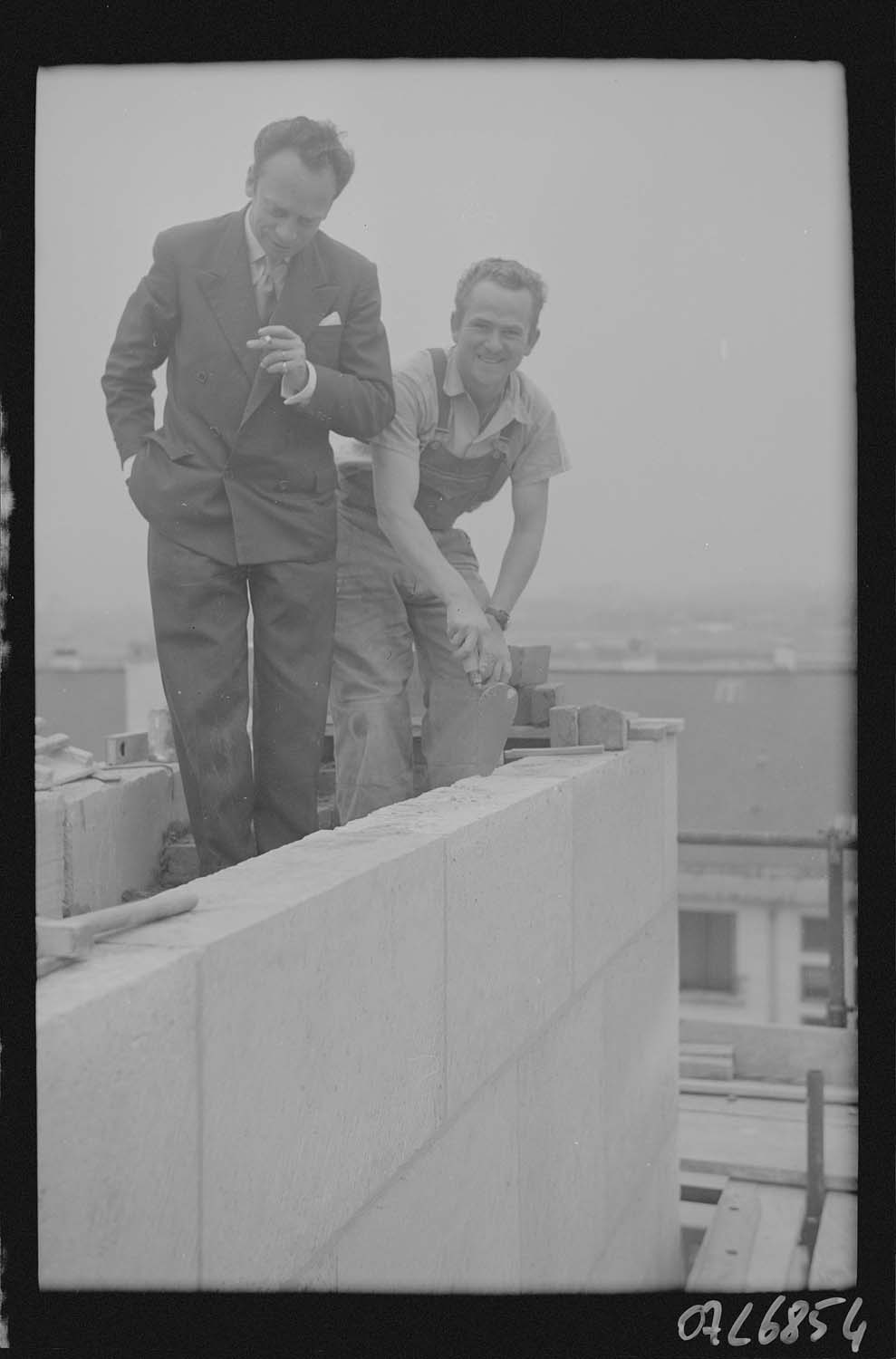 Personnages (Jullien ? et ouvrier) en haut du mur