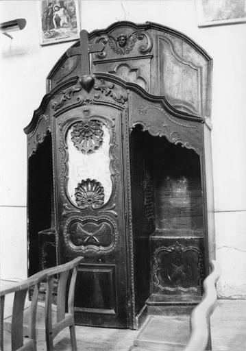 Confessionnal richement sculpté de coquilles et de volutes, surmonté d'une sorte de fronton mouluré au chérubin en relief, bois taillé, sculpté - © Ministère de la Culture (France), Médiathèque du patrimoine et de la photographie (objets mobiliers), tous droits réservés