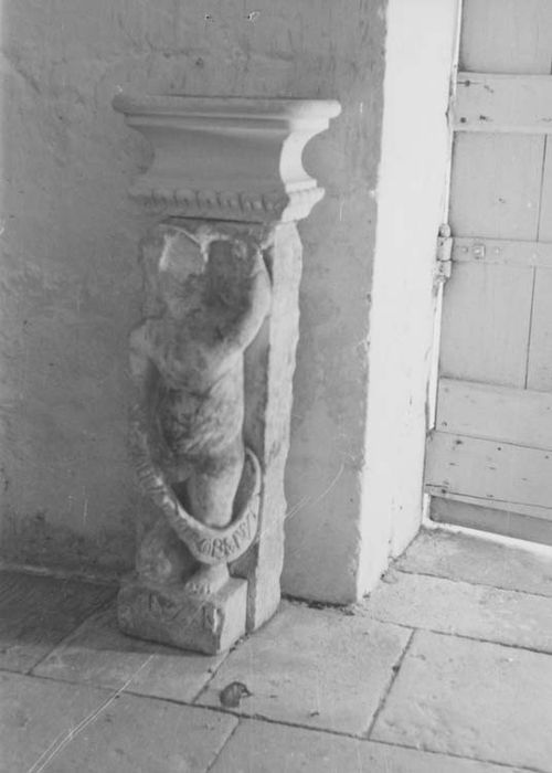 socle de bénitier : personnage tenant un phylactère
