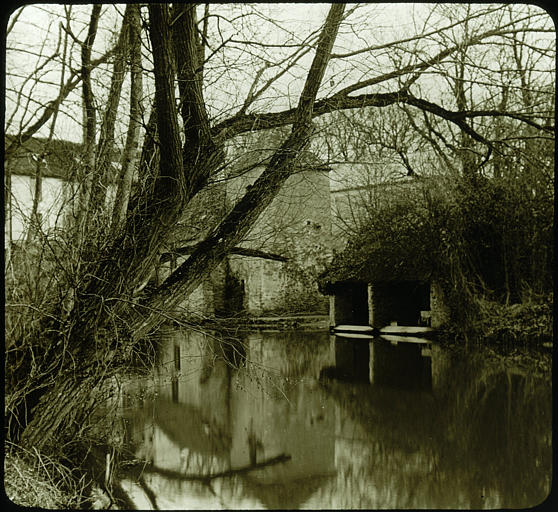 Rivière, lavoir, arbres, moulin à l'arrière-plan