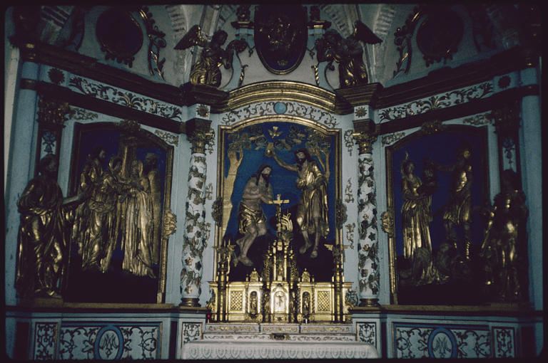 Choeur, maître-autel ; tabernacle, retable, bas-reliefs (3), statues (2) : 'La Visitation' (gauche), 'Le baptême du Christ' (centre), 'La décollation de saint Jean-Baptiste' (droite), 'Saint Pierre' (gauche), 'Sainte Catherine' (droite), anges, colonnes torses, frise de vigne, rinceaux (vue d'ensemble)