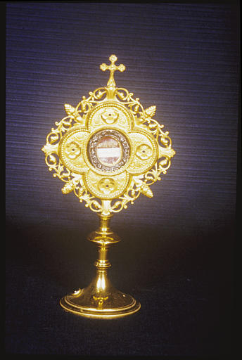 Reliquaire-monstrance : motif central quadrilobé, rinceaux végétaux, pommes de pin, médaillon, croix