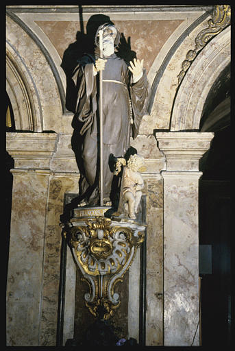 Groupe sculpté : 'Saint François de Paule', bourdon dans la main gauche, angelot assis à ses pieds, pierre sculptée, peinte