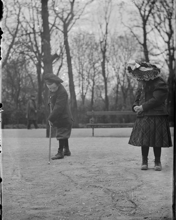 Marthe et Jean dessinant des formes dans le sol à l'aide de bâtons