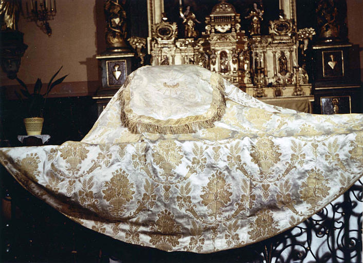 Chape en soie blanche et fils d'or tissés, à motif répétitif de corbeille de fleurs cerclée d'épis de blé et de grappes de raisin, chaperon à motif décoratif brodé