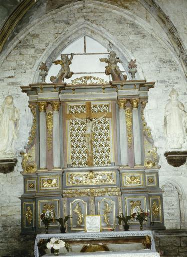 Retable, statue : Christ en croix, retable architecturé orné de panneaux sculptés de chérubins, fleurs, palmes et médaillons aux visages de saints personnages, surmonté de deux anges, bois sculpté, peint, doré - © Ministère de la Culture (France), Médiathèque du patrimoine et de la photographie (objets mobiliers), tous droits réservés