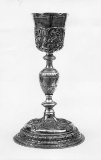 Calice à fausse coupe ornée de volutes, épis de blé et grappes de raisin, noeud présentant coquilles et volutes, pied à motifs géométriques, grappes de raisin et épis de blés placés dans des réserves, argent