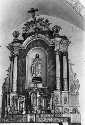 Tabernacle, retable, statue : Le Sacré Coeur, tabernacle architecturé à trois travées, agrémenté de statuettes, retable architecturé surmonté d'un petit fronton cintré aux deux angelots portant un crucifix, bois sculpté, peint, doré - © Ministère de la Culture (France), Médiathèque du patrimoine et de la photographie (objets mobiliers), tous droits réservés