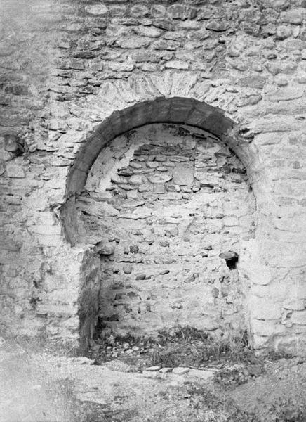 Eglise abbatiale : bas-côté sud, porte murée à arc outrepassé