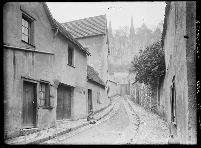 Vieille rue, mur avec lierre et cathédrale au fond