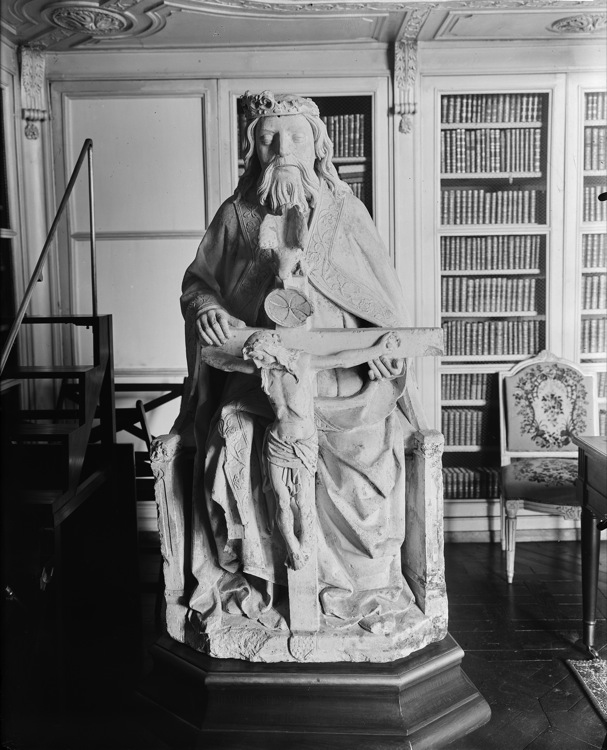 Statue : roi assis sur un trône présentant le Christ crucifié