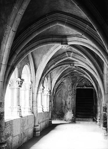 Cloître : vue intérieure de la galerie est vers la porte conduisant à l'église