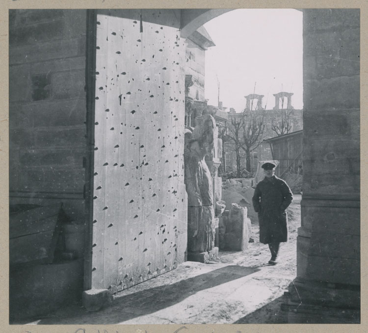 Porte latérale donnant sur la cour d'honneur du palais archiépiscopal ; Prisonnier allemand chef d'équipe travaillant au déblaiement de la cathédrale