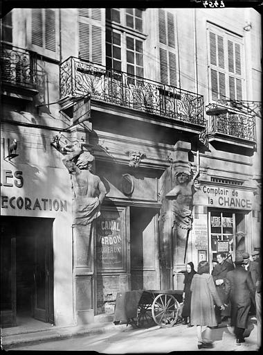 Porte d'entrée : encadrement de deux atlantes en pierre de taille
