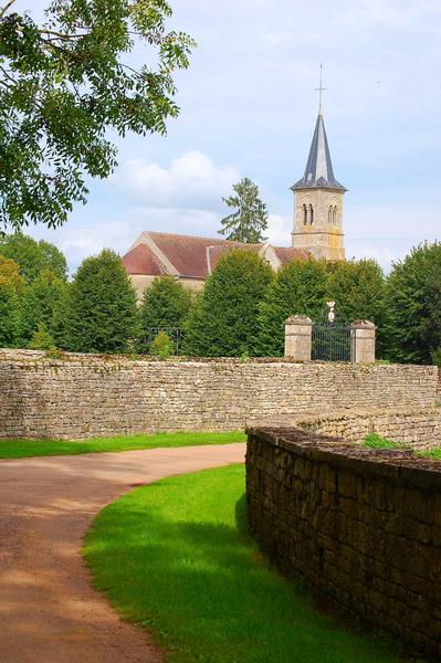 vue partielle du mur de clôture du parc, clocher de l'église paroissiale