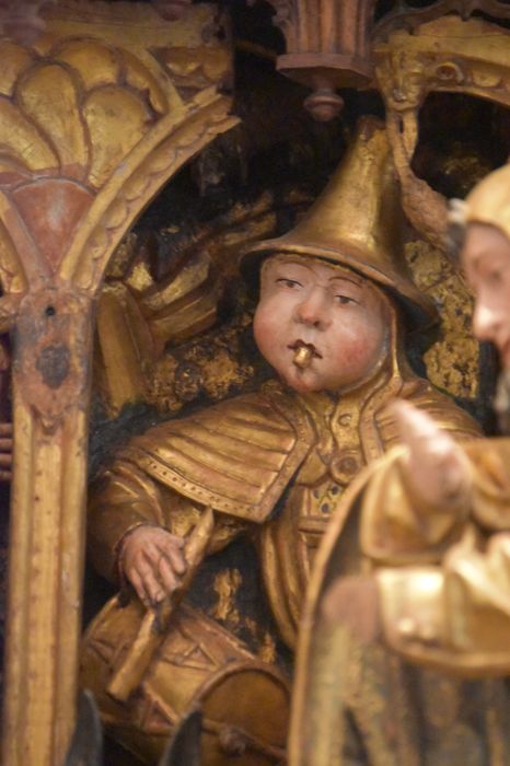 retable : scènes de la vie de la Vierge, l'Arbre de Jessé, détail : visage d’un joueur de musique dans la scène de la Nativité