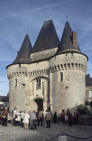 Touristes devant la porte de ville fortifiée