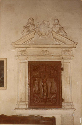 Armoire à reliquaire : ensemble de la porte en bois sculptée d'un bras-reliquaire et du décor architecturé à fronton brisé orné de deux personnages et d'un cartouche - © Ministère de la Culture (France), Médiathèque du patrimoine et de la photographie (objets mobiliers), tous droits réservés