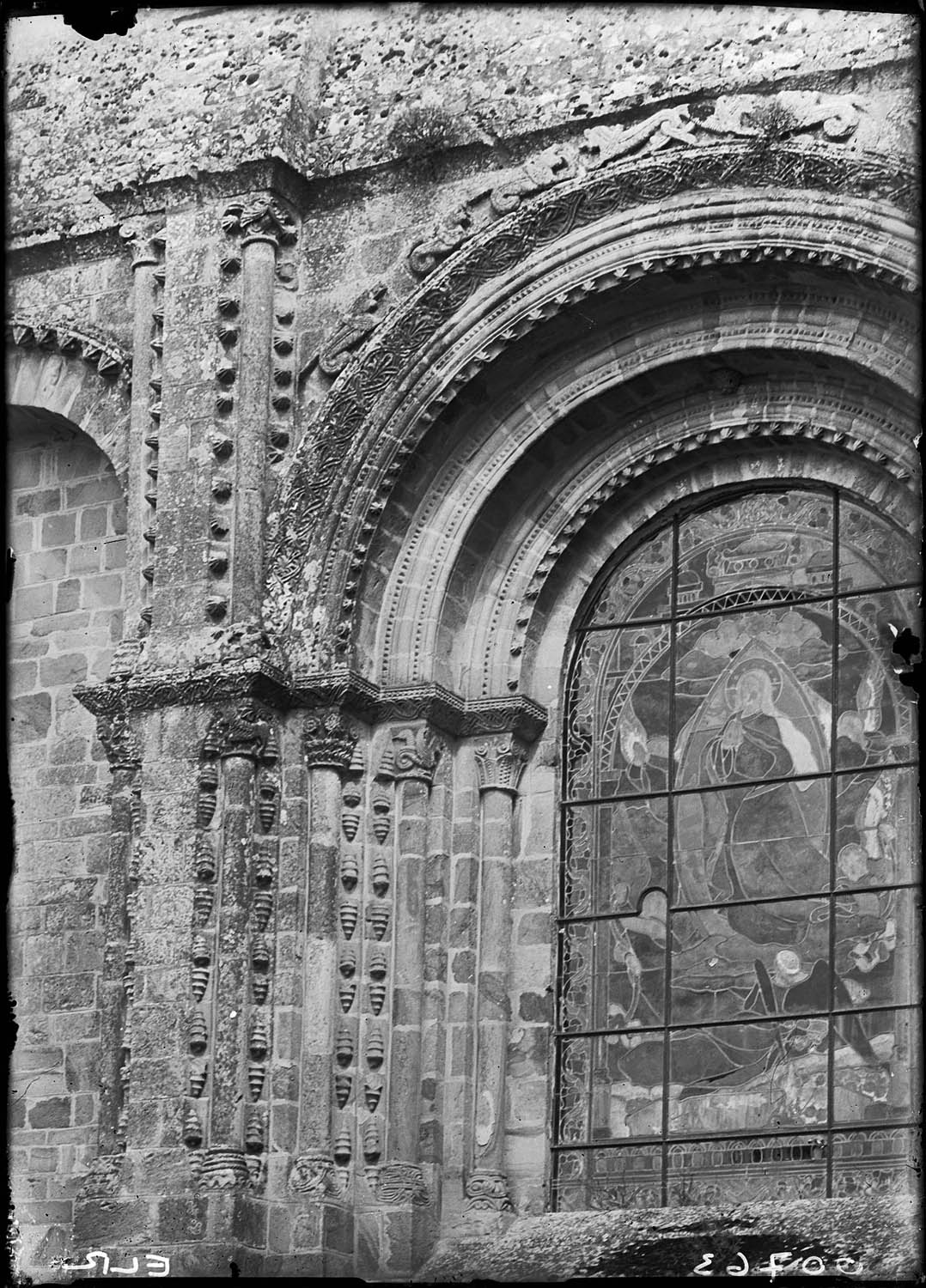 Fenêtre de la façade ouest avec vitrail et encadrement sculpté