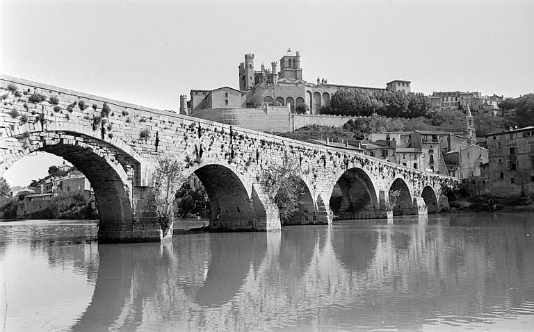 Vue d'ensemble des grandes arches du pont, avec le palais de justice et l'église Saint-Jude en arrière-plan