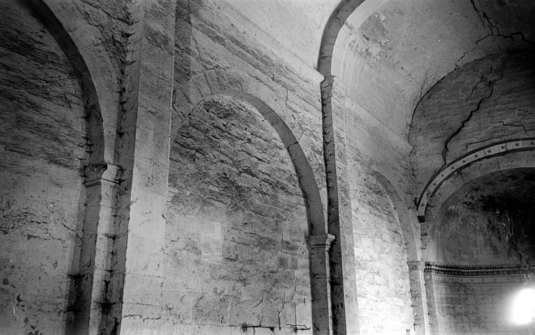 Vue intérieure de l'église : arcades aveugles de la nef et départ de la voûte en berceau