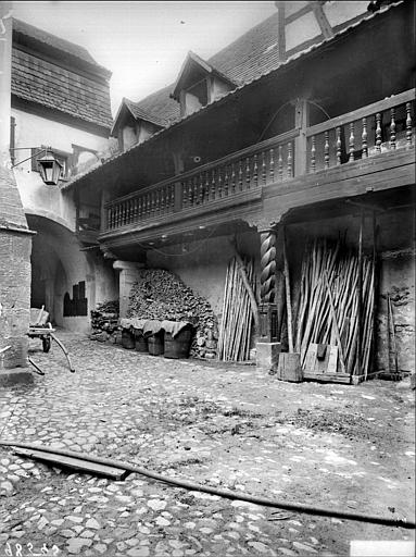 Cour intérieure : porche et galerie avec balustrade en bois