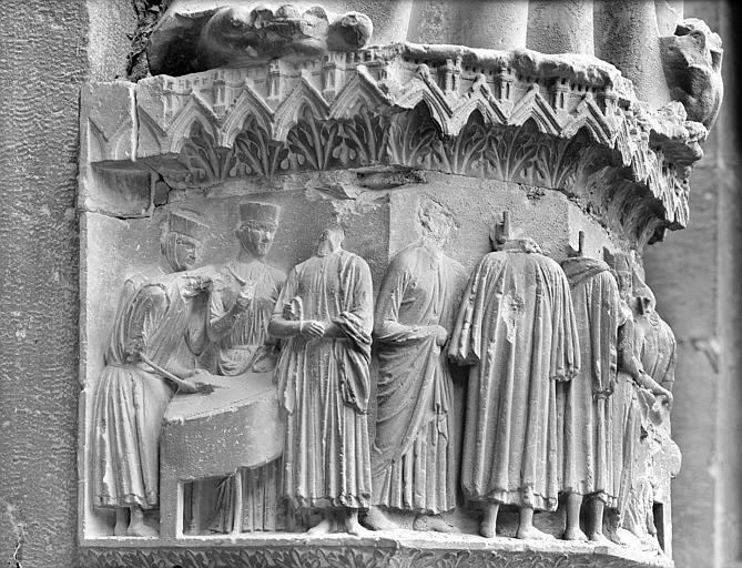 Façade nord, portail du Jugement dernier : Moitié gauche du socle de la statue du trumeau représentant en bas-relief le Christ et les marchands