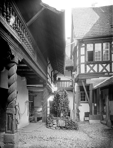 Façade sur cour à pans de bois à galerie. Puits