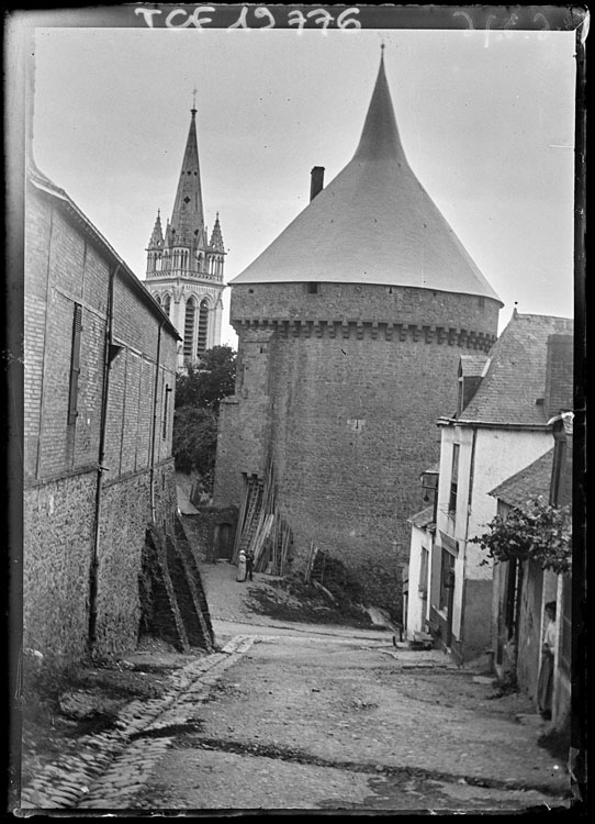 Perspective sur une tour d’angle, le clocher de l’église en arrière-plan