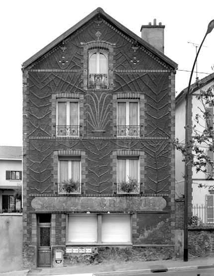 Vue de la façade antérieure présentant un décor en ciment armé imitant le bois.