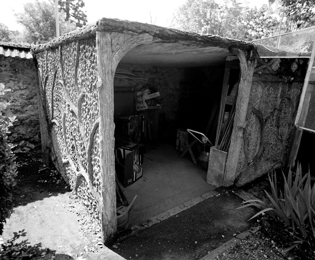 Cabane de jardin en ciment imitant le bois écoté.