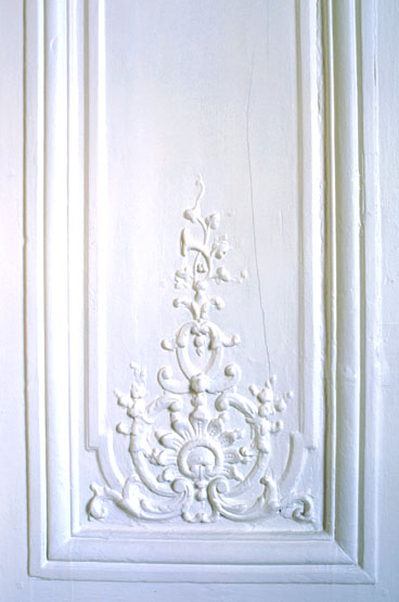Détail du lambris de hauteur ornant l'ébrasement d'une porte entre le salon de compagnie et la chambre à alcôve.