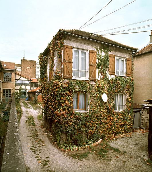 En milieu de parcelle, le pavillon d'habitation coiffé d'un toit à croupe.