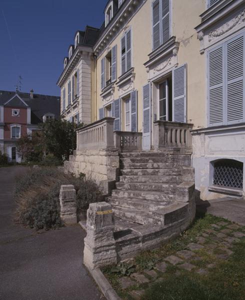 Vue de la montée de droite de l'escalier en fer à cheval situé devant la façade principale.