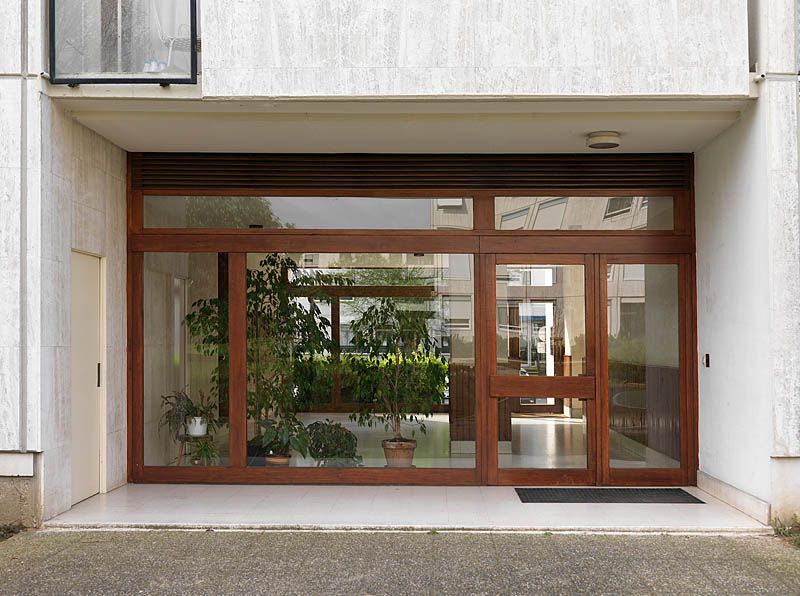 Vue d'un hall d'entrée permettant le passage entre l'avenue Nationale et les espaces verts intérieurs. Les huisseries ont été remplacées à l'identique.