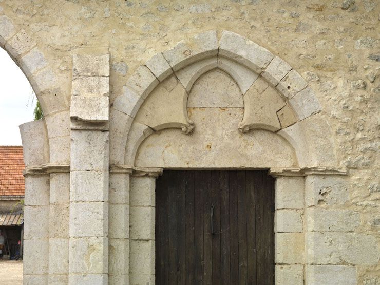Détail du tympan en tiers-point et de l'arcature trilobée de la porte piétonne.