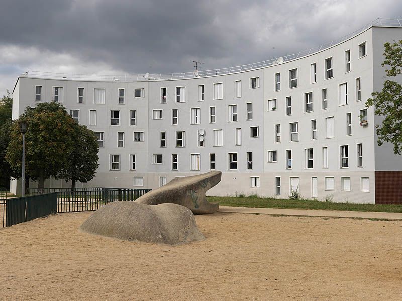 Quartier des Radras, vue de la place de l'étang avec une sculpture de serpent en béton.