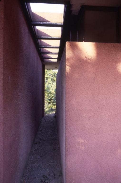 Vue d'un passage reliant le garage au jardin. 