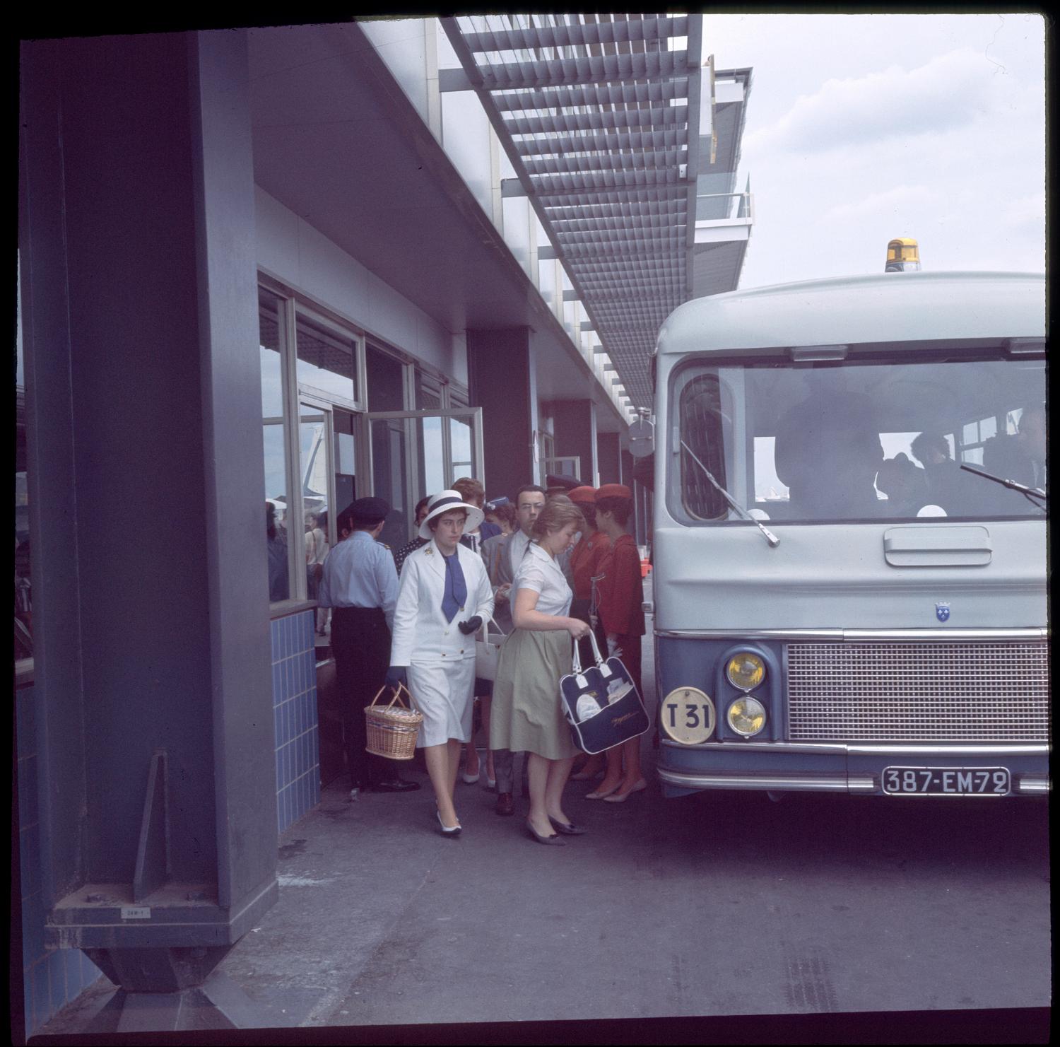 1961, l'embarquement des passagers: l'accès à l'avion par bus.