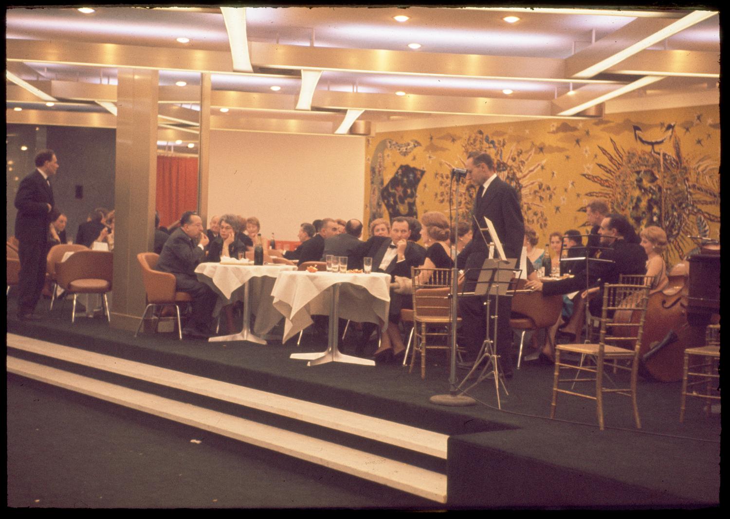 1961, les Trois Soleils, conception des aménagements André Renou et Jean-Pierre Génisset (la Crémaillère), fauteuils Conférence (Eero Saarinen), au fond de la salle la tapisserie de Jean Lurçat qui donne son nom au restaurant, 3ème étage.  ; 1961, les Trois Soleils, conception des aménagements André Renou et Jean-Pierre Génisset (la Crémaillère), au fond de la salle la tapisserie de Jean Lurçat qui donne son nom au restaurant, 3ème étage. 