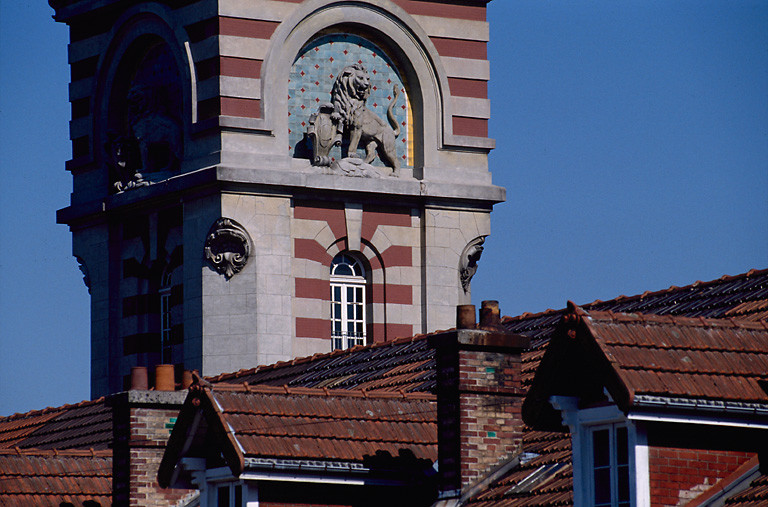 Détail des céramiques et des sculptures au sommet du château d'eau.