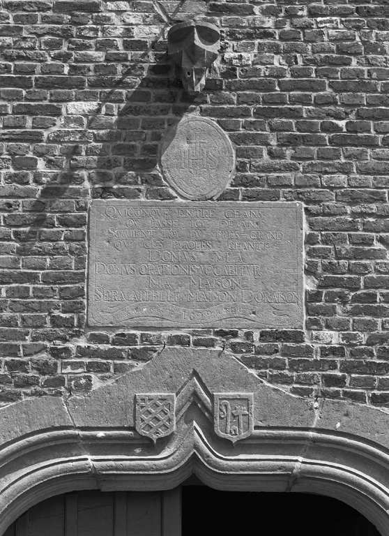 Détail de deux blasons armoriés et d'une inscription datée de 1629 sur la façade de l'église.